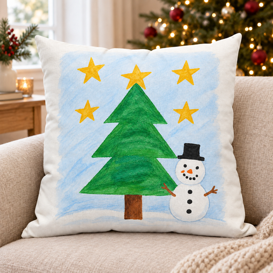 Cushion showing sample snowman and Christmas tree artwork in a Christmas setting