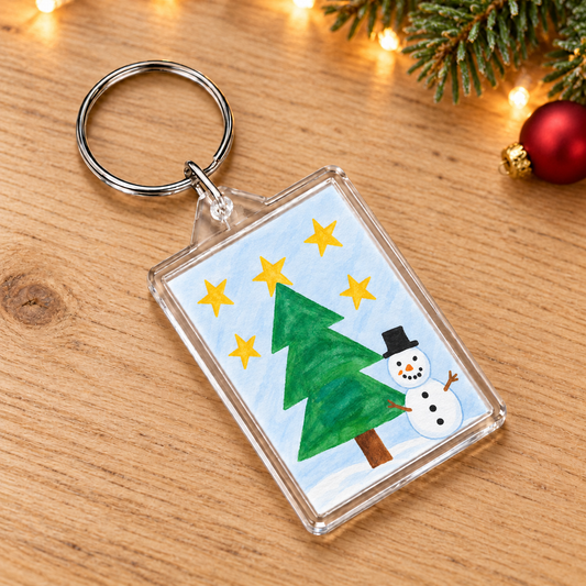 Key Ring showing sample snowman and Christmas tree artwork in a Christmas setting