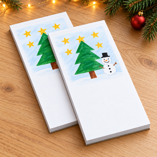 Notepad showing sample snowman and Christmas tree artwork in a Christmas setting